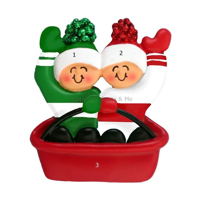 sledding couple ornament